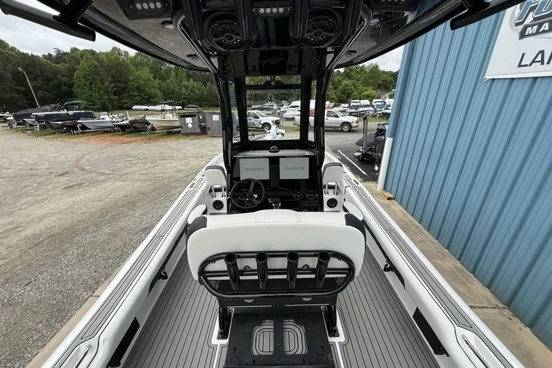 Slide: The Image of 2026 Tidewater 2500 Carolina Bay boat interior with Garmin navigation, docked near blue building. - 45