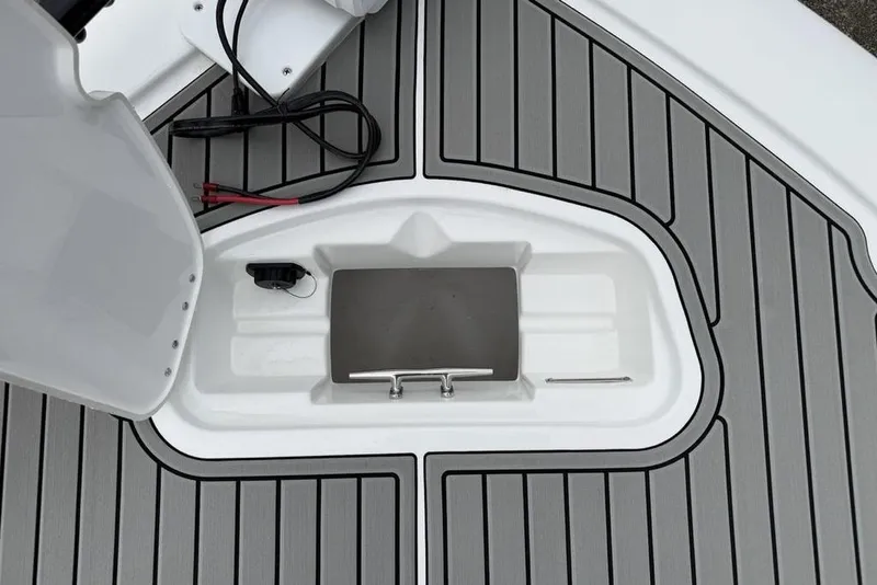 Slide: The Image of 2026 Tidewater 2500 Carolina Bay boat deck with storage compartment and sleek design. - 5