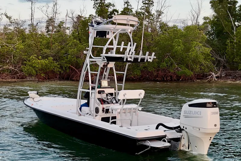 Slide: The Image of 2009 ShearWater 2400Z boat with Suzuki 300 engine on calm water near mangroves. - 10