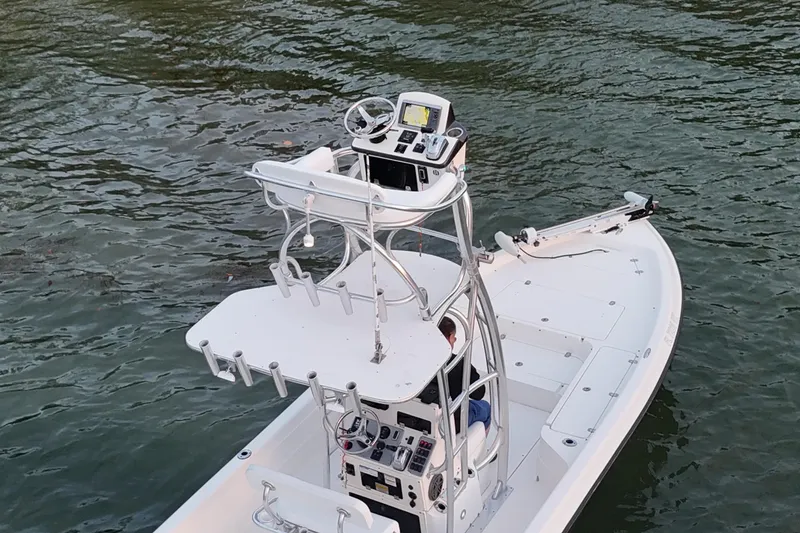 Slide: The Image of 2009 ShearWater 2400Z boat with elevated helm, navigating on calm waters. - 11