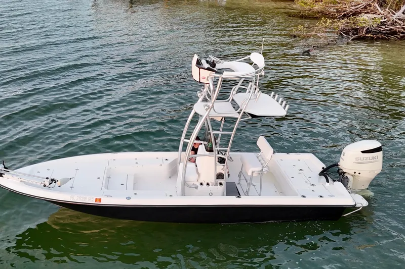 Slide: The Image of 2009 ShearWater 2400Z boat with Suzuki outboard motor on calm water. - 16