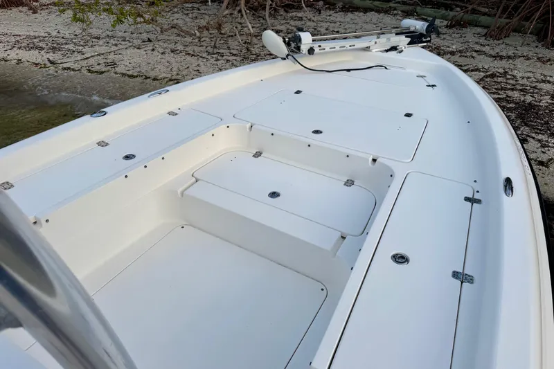 Slide: The Image of 2009 ShearWater 2400Z boat deck with storage compartments and trolling motor. - 17