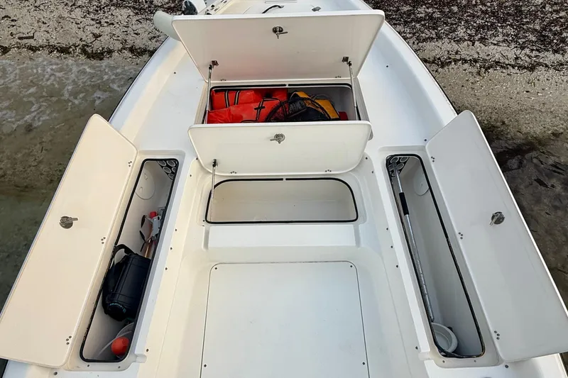 Slide: The Image of 2009 ShearWater 2400Z boat storage compartments with safety gear and equipment. - 18