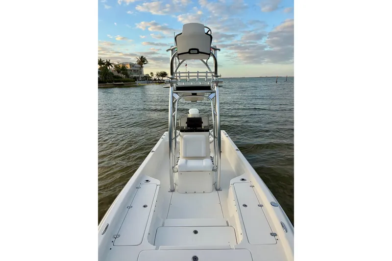 Slide: The Image of 2009 ShearWater 2400Z boat on calm water under a partly cloudy sky. - 19