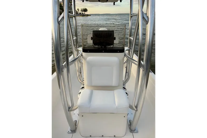 Slide: The Image of 2009 ShearWater 2400Z boat interior with white seating and metal framework, overlooking serene water. - 20