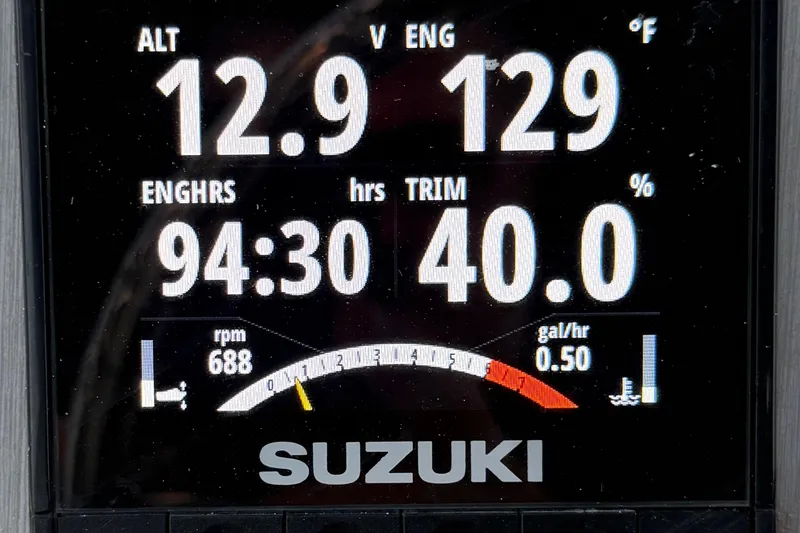 Slide: The Image of Digital display of a 2009 ShearWater 2400Z boat showing engine metrics and Suzuki branding. - 23