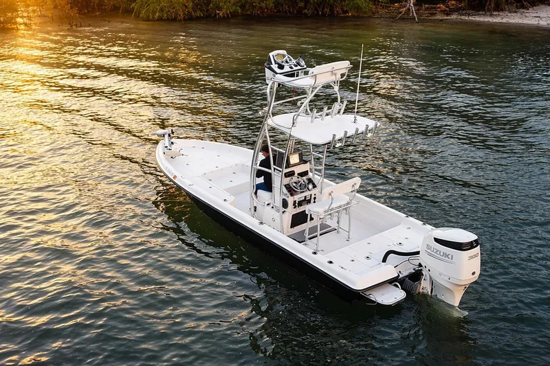 Slide: The Image of 2009 ShearWater 2400Z boat on water at sunset with Suzuki engine. - 3