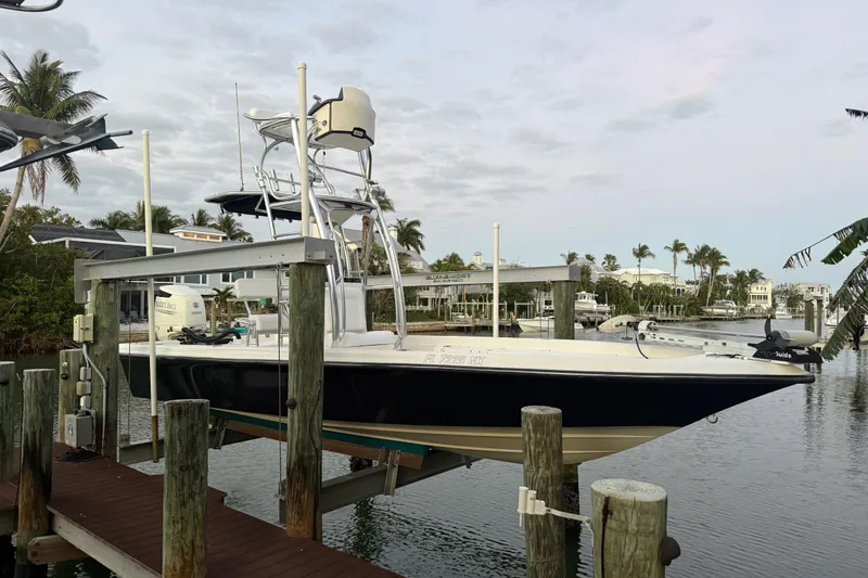 Slide: The Image of 2009 ShearWater 2400Z boat docked at a marina with palm trees in the background. - 32