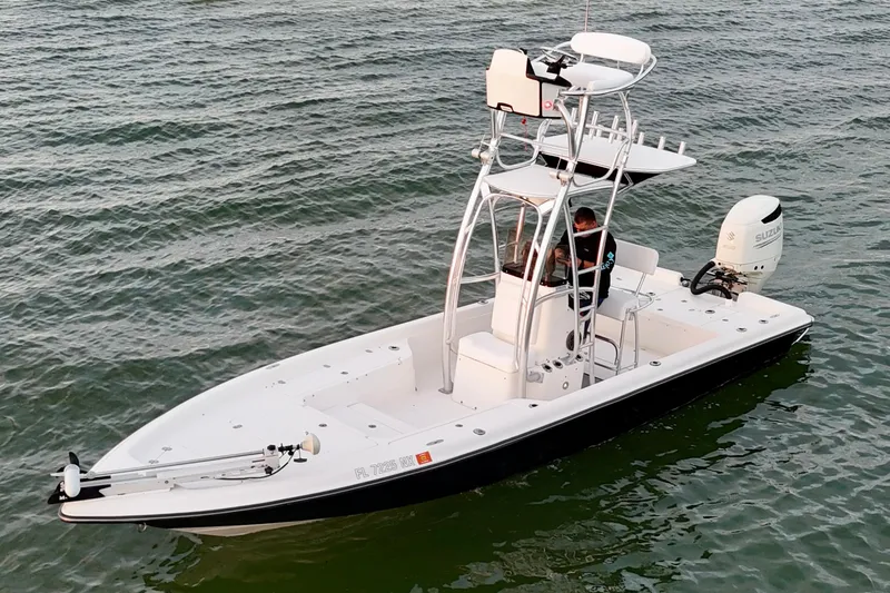 Slide: The Image of 2009 ShearWater 2400Z boat on water with Suzuki outboard motor. - 5