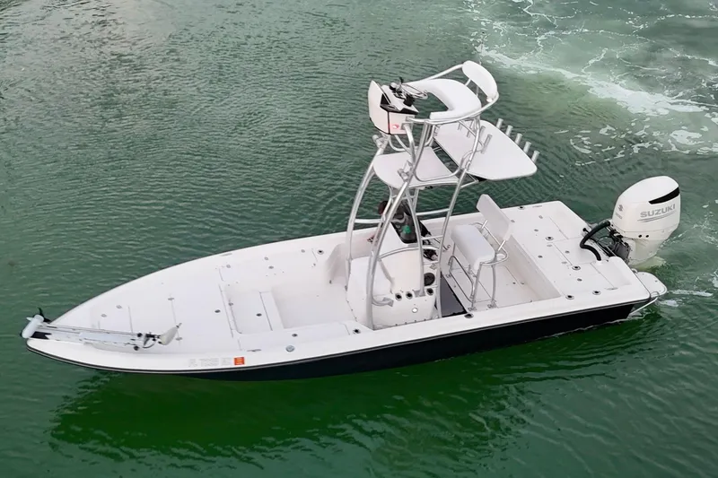 Slide: The Image of 2009 ShearWater 2400Z boat with Suzuki outboard motor on green water. - 6