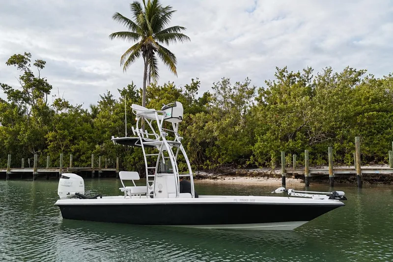 Slide: The Image of 2009 ShearWater 2400Z boat on calm water near tropical shoreline. - 8