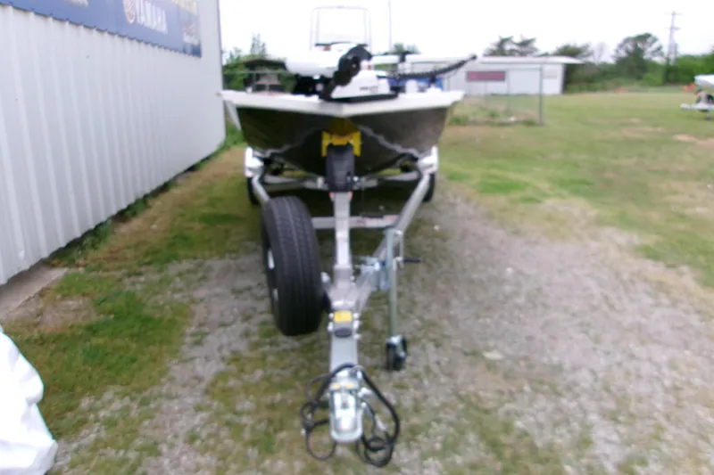 Slide: The Image of 2026 Xpress H22B Bay boat on trailer, parked outdoors near a building. - 19