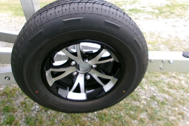 Slide: The Image of 2026 Xpress H22B Bay trailer wheel with black and silver alloy rim. - 20