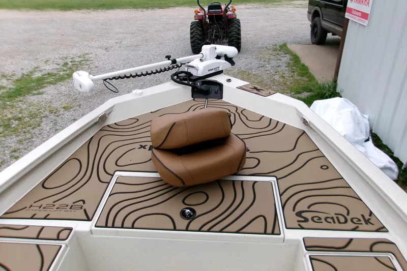 Slide: The Image of 2026 Xpress H22B Bay boat with SeaDek flooring and Minn Kota trolling motor. - 25