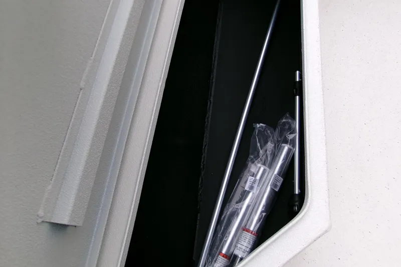 Slide: The Image of Storage compartment of 2026 Xpress H22B Bay boat with packaged metal rods. - 26