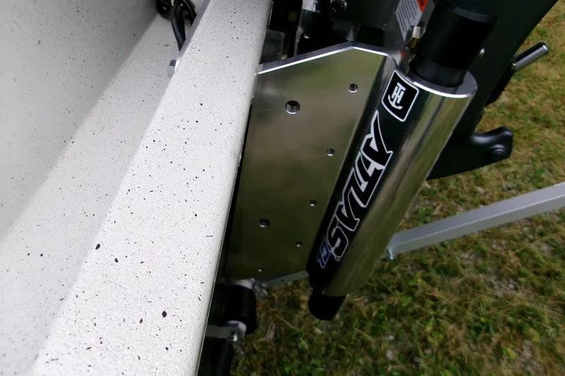 Slide: The Image of 2026 Xpress H22B Bay boat detail with Atlas jack plate on grassy background. - 8