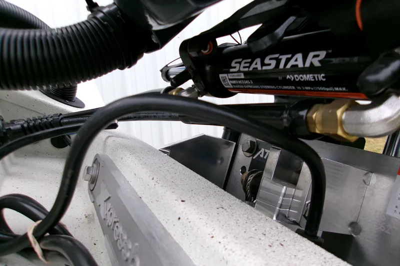 Slide: The Image of Close-up of 2026 Xpress H22B Bay boat's SeaStar hydraulic steering system. - 9