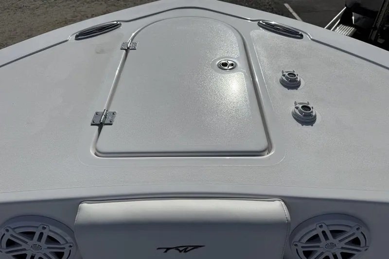 Slide: The Image of 2026 Tidewater 232 LXF boat deck with storage hatch and speakers. - 10