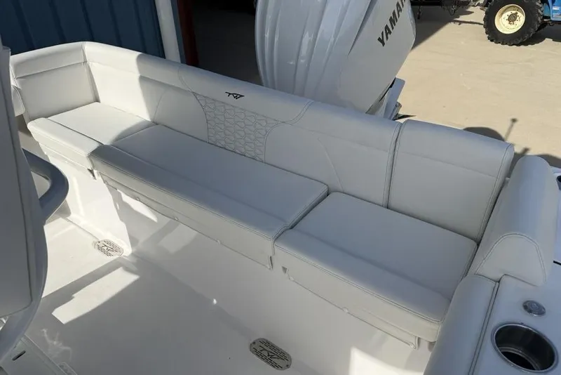 Slide: The Image of 2026 Tidewater 232 LXF boat with white cushioned seating and Yamaha engine. - 13