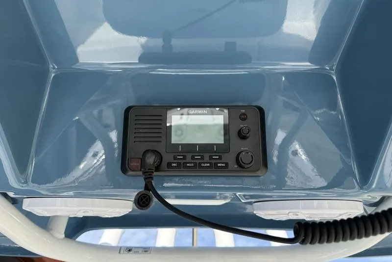 Slide: The Image of Garmin marine radio on 2026 Tidewater 232 LXF boat dashboard. - 14