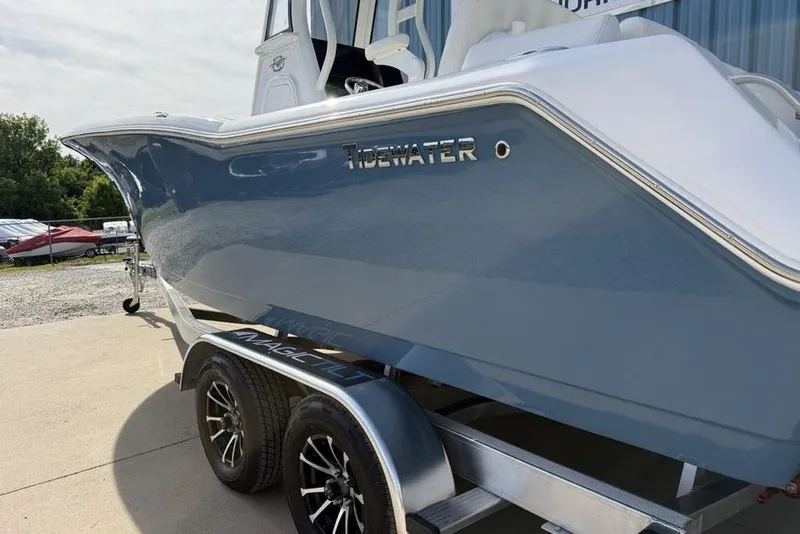 Slide: The Image of 2026 Tidewater 232 LXF boat on trailer, showcasing sleek blue hull design. - 15