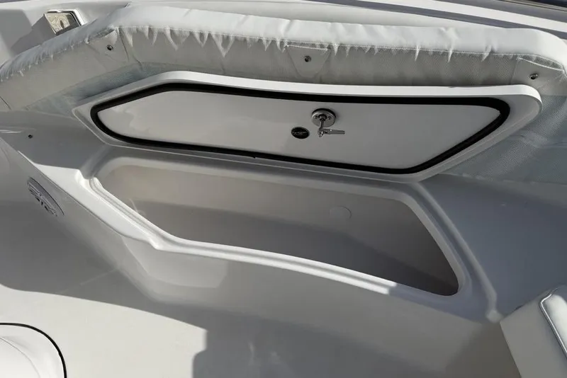 Slide: The Image of Storage compartment on 2026 Tidewater 232 LXF boat, featuring secure lock and cushioned seating. - 17