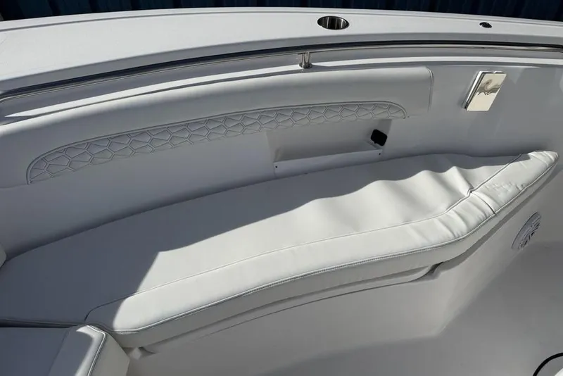 Slide: The Image of 2026 Tidewater 232 LXF boat interior with white cushioned seating and elegant design. - 19