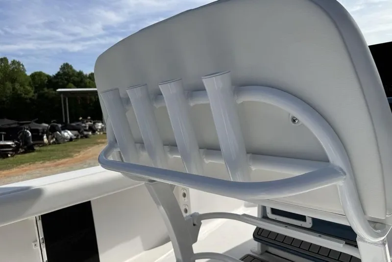 Slide: The Image of 2026 Tidewater 232 LXF boat seat with integrated rod holders, outdoor setting. - 20