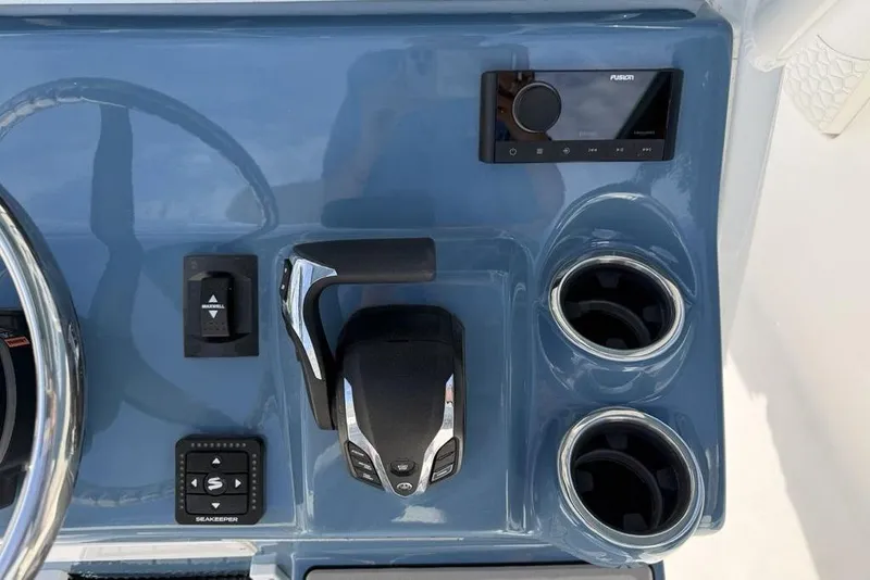 Slide: The Image of Control panel of 2026 Tidewater 232 LXF boat with steering wheel and cup holders. - 21