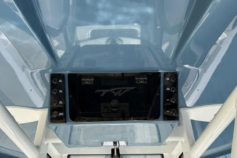 Slide: The Image of 2026 Tidewater 232 LXF boat console with control panel and storage compartment. - 23