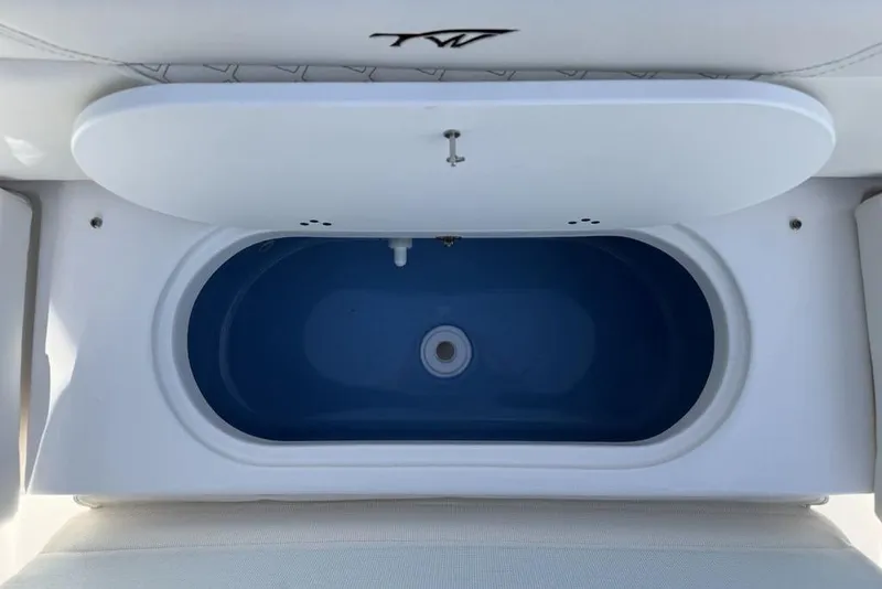 Slide: The Image of 2026 Tidewater 232 LXF boat livewell with open lid, showcasing interior design. - 25