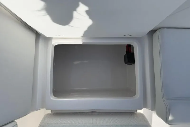 Slide: The Image of Open storage compartment on 2026 Tidewater 232 LXF boat interior. - 26