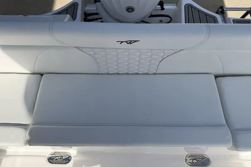 Slide: The Image of 2026 Tidewater 232 LXF boat interior with white cushioned seating and logo detail. - 27