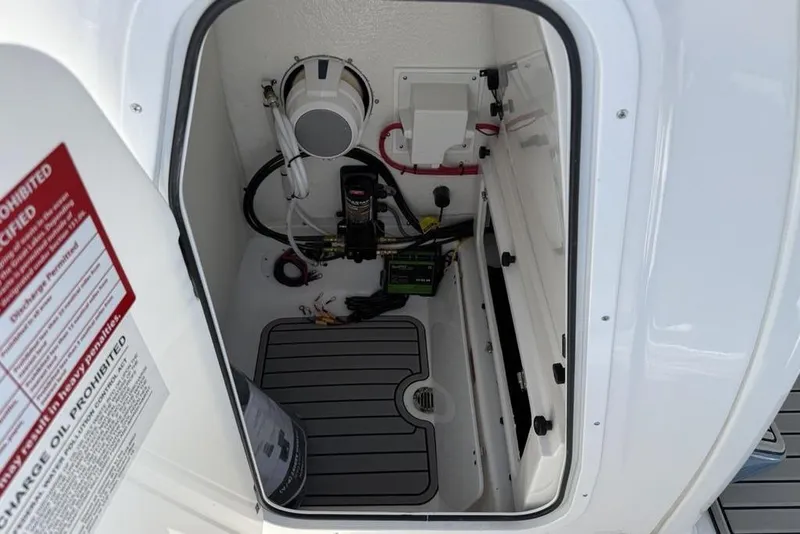 Slide: The Image of Interior compartment of 2026 Tidewater 232 LXF boat, showing equipment and wiring. - 28
