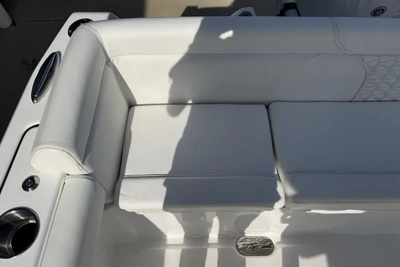 Slide: The Image of White seating on 2026 Tidewater 232 LXF boat, featuring sleek design and cup holder. - 29