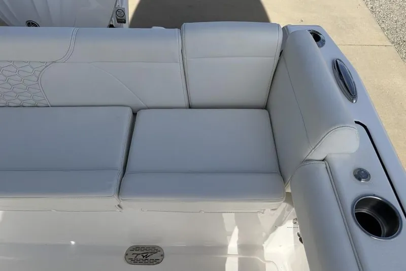 Slide: The Image of 2026 Tidewater 232 LXF boat seating with white upholstery and cup holders. - 34