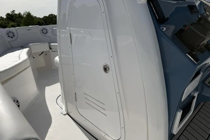 Slide: The Image of 2026 Tidewater 232 LXF boat interior with seating and storage compartment. - 37
