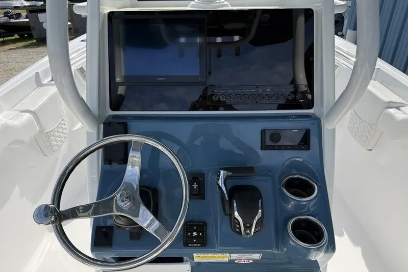 Slide: The Image of Helm of 2026 Tidewater 232 LXF boat with steering wheel and control panel. - 38