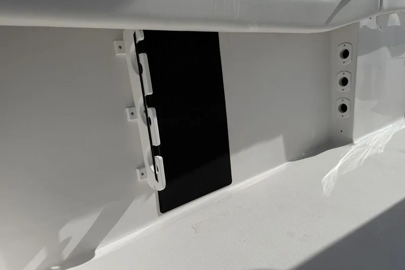 Slide: The Image of 2026 Tidewater 232 LXF boat interior detail with storage compartment and rod holders. - 39