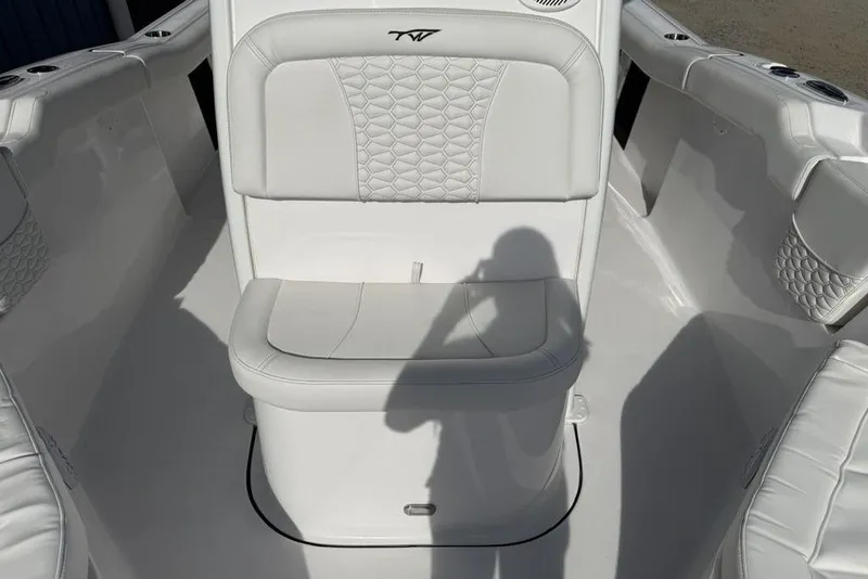 Slide: The Image of 2026 Tidewater 232 LXF boat interior with white cushioned seating and elegant design. - 4