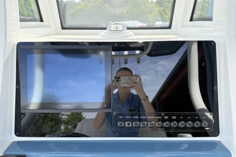 Slide: The Image of 2026 Tidewater 232 LXF boat dashboard with Garmin display and control panel. - 8