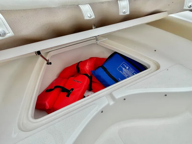Slide: The Image of Pioneer 2020 202 Sportfish boat with life jackets in storage compartment. - 24
