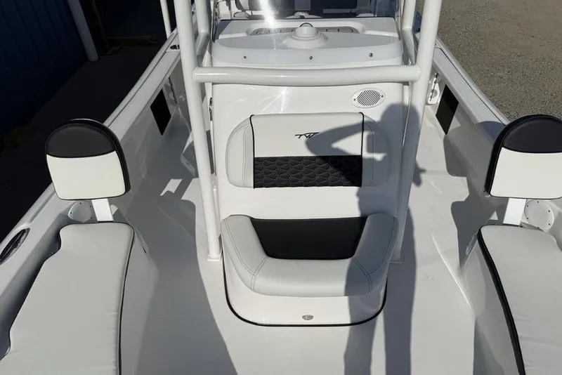Slide: The Image of 2025 Tidewater 2210 Carolina Bay boat interior with white seating and black accents. - 6
