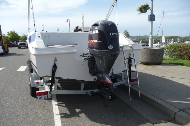 Slide: The Image of 2022 Starcraft SVX 171 OB boat with Yamaha 115 engine on trailer, parked near marina. - 12