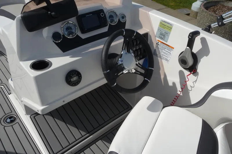 Slide: The Image of 2022 Starcraft SVX 171 OB boat cockpit with steering wheel and control panel. - 17