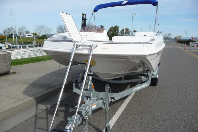 Slide: The Image of 2022 Starcraft SVX 171 OB boat on trailer, parked near marina. - 5