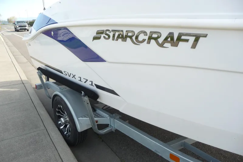 Slide: The Image of 2022 Starcraft SVX 171 OB boat on trailer, parked on roadside. - 7