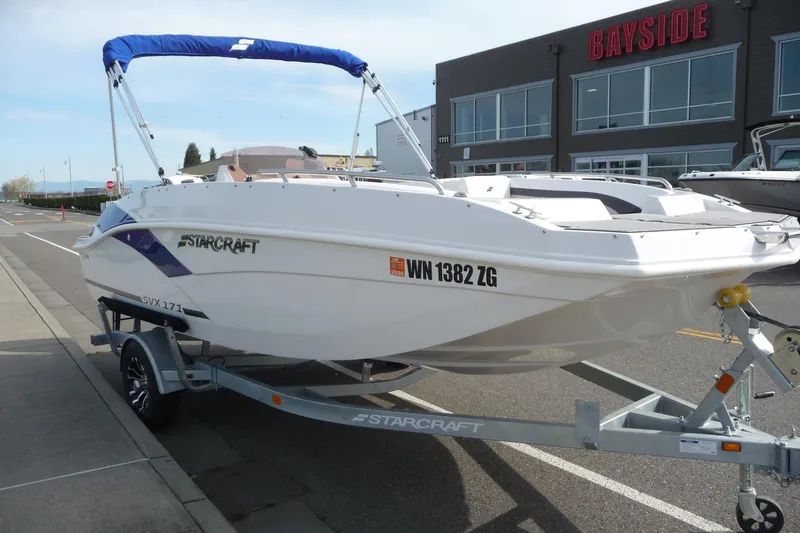 Slide: The Image of 2022 Starcraft SVX 171 OB boat on trailer, parked outside Bayside dealership. - 8