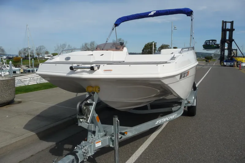 Slide: The Image of 2022 Starcraft SVX 171 OB boat on trailer, parked near marina. - 9