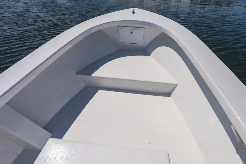 Slide: The Image of Bow of a 1979 Privateer 20 boat on calm water, showcasing clean white interior. - 11